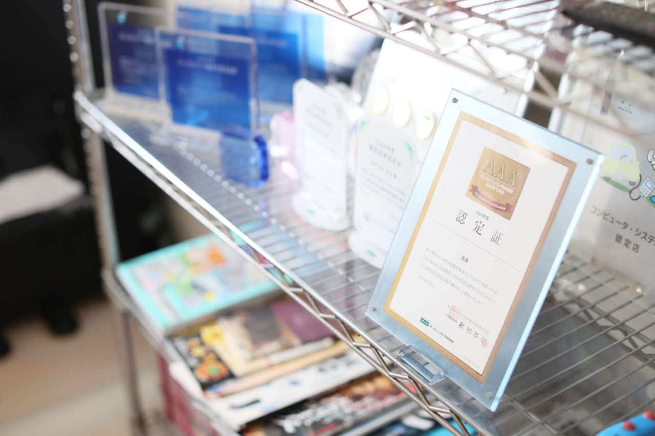 書店の金属棚に陳列された書籍と認定証